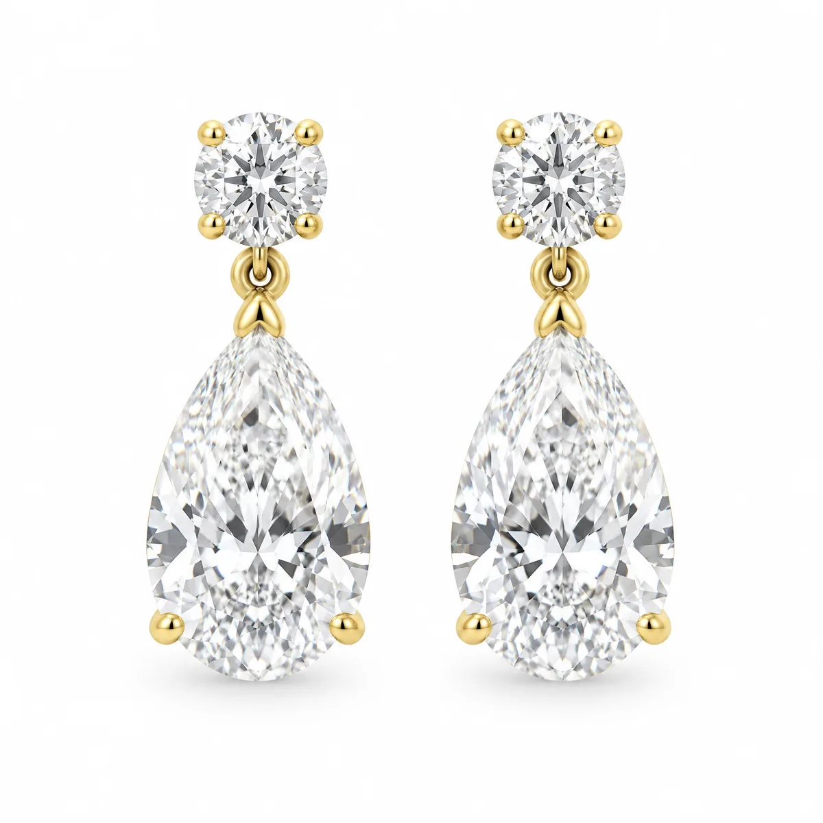 Pear drop earrings: A round diamond stud with a pear-shaped diamond drop, in 18k yellow gold