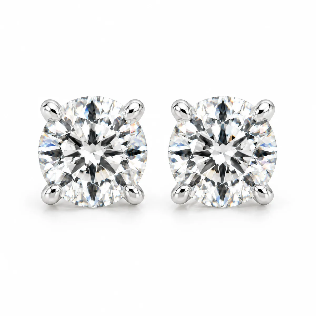 Solitaire studs: Round brilliant diamond studs in four-prong 18k white gold martini settings