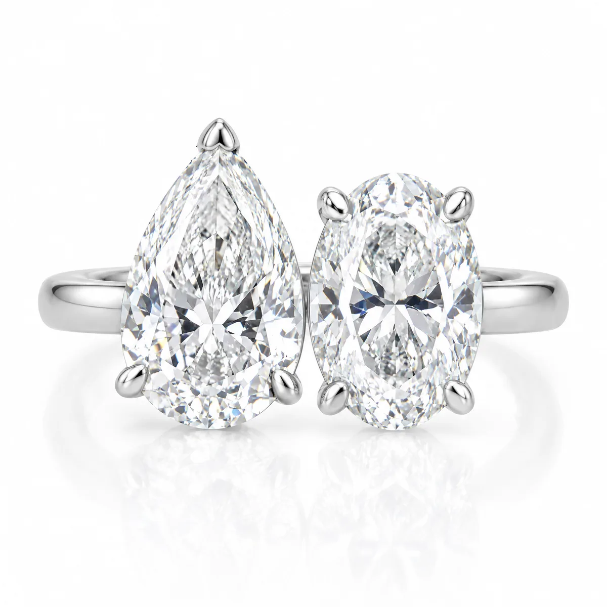 Toi et moi ring: Pear and oval diamonds side by side on an open 18k white gold band